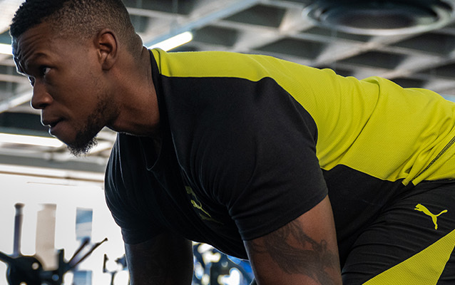 Man lifting weights at a Planet Fitness branch